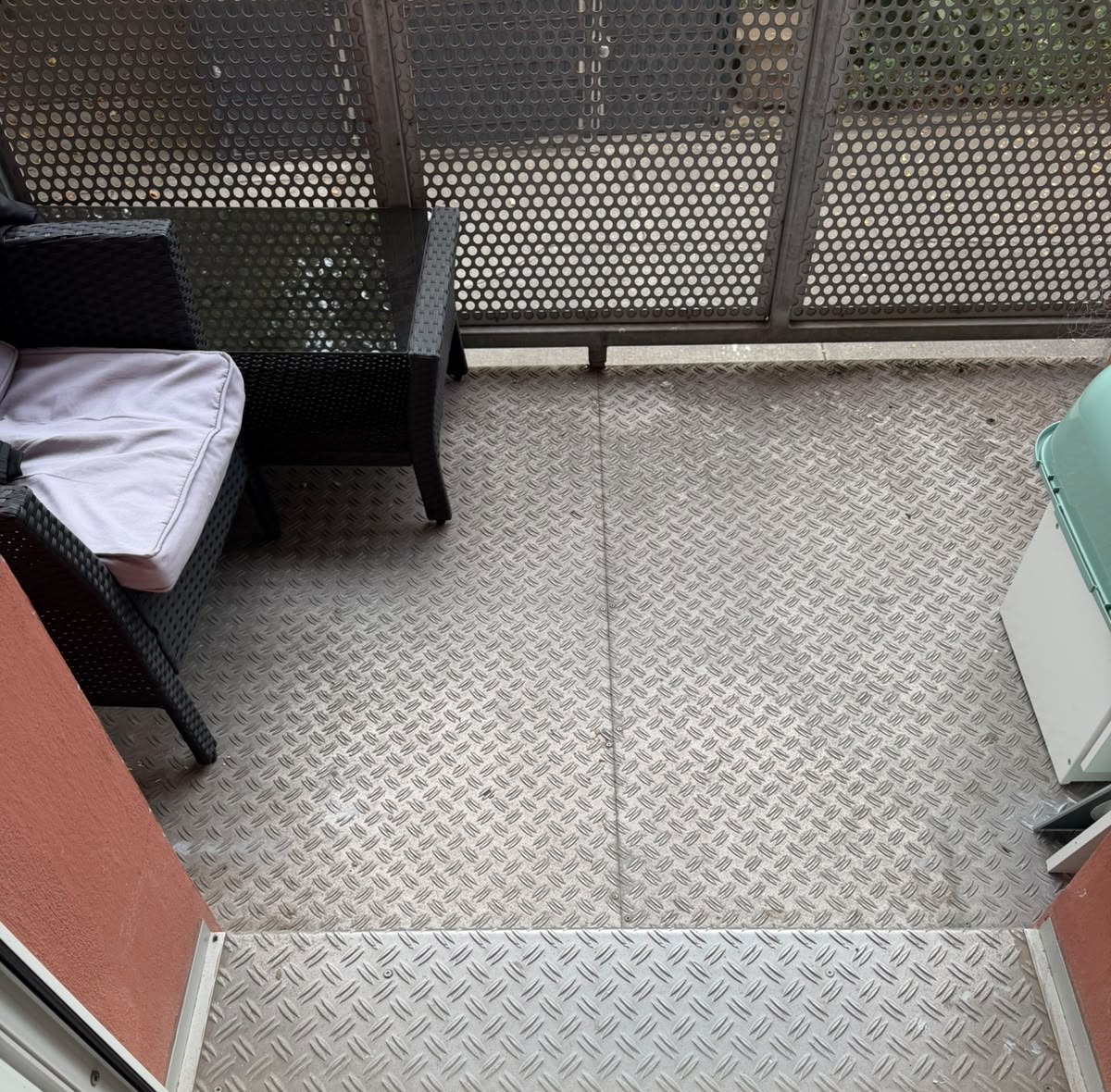 Blick aus der Balkontür auf den Boden aus Riffelblech und das Geländer aus Lochblech meines hinteren Balkons